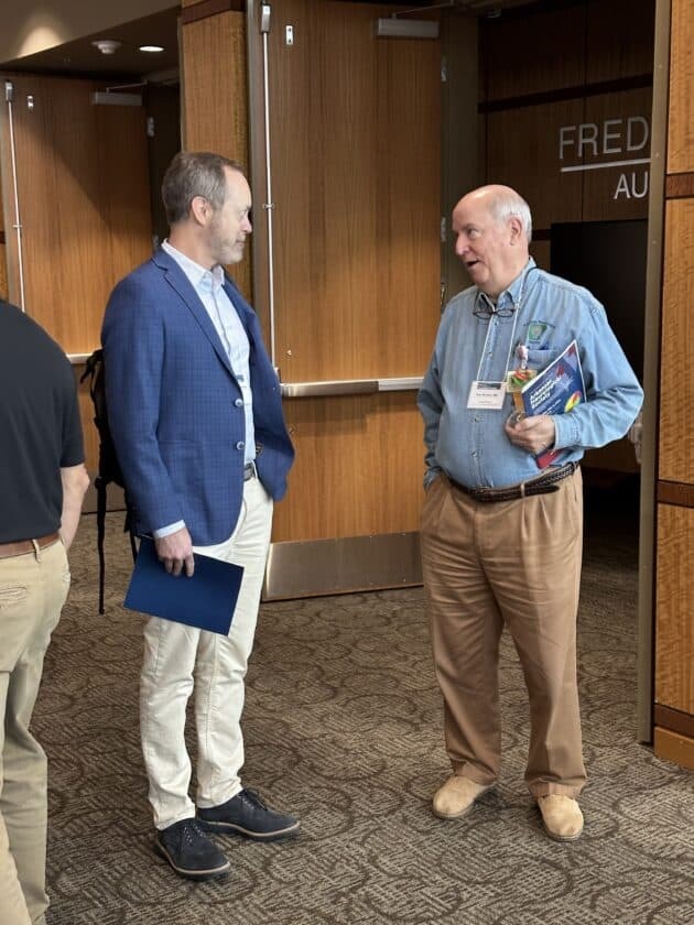 Two attendees speaking together at the 2024 ANS Annual Meeting.